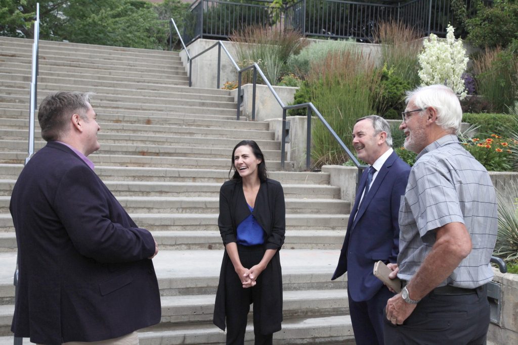 Delegation from the Irish Consulate in Vancouver with representatives from the UBC Okanagan International Office in conversation front of staircase on UBC Okanagan campus.